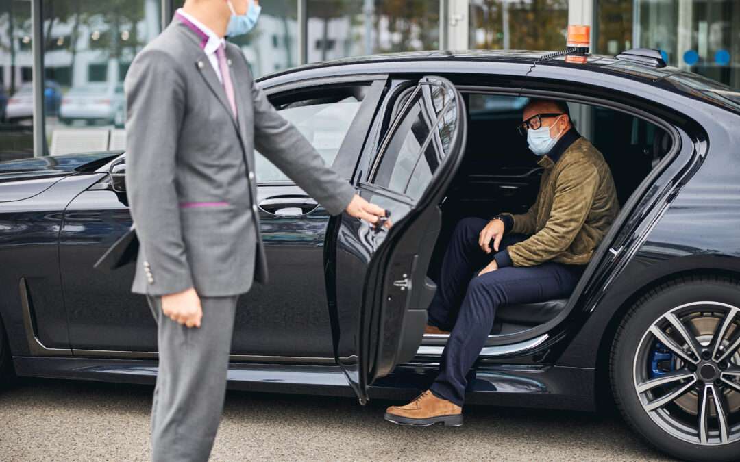 Chauffeur,Opening,The,Car,Door,For,A,Caucasian,Male,Passenger